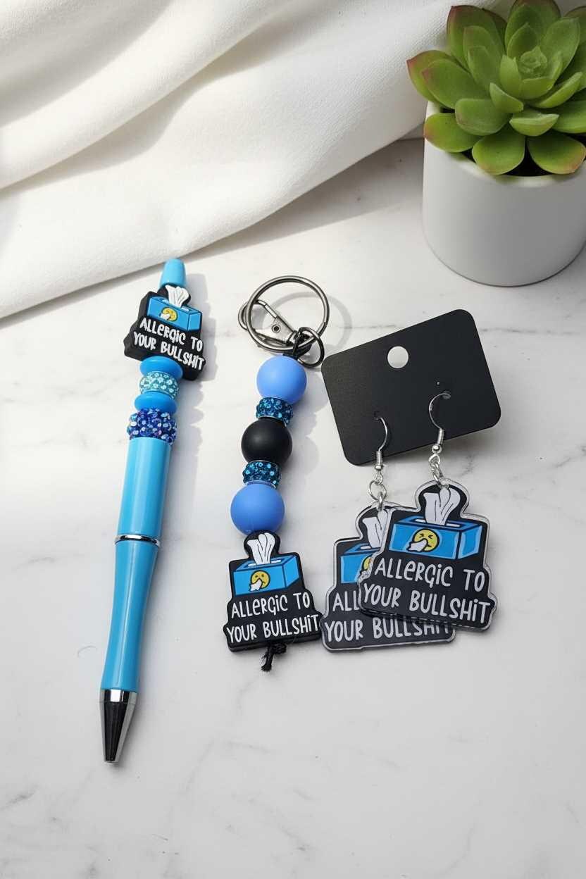 Sassy gift set with blue pen, beaded keychain, and 'Allergic to Your Bullshit' earrings.