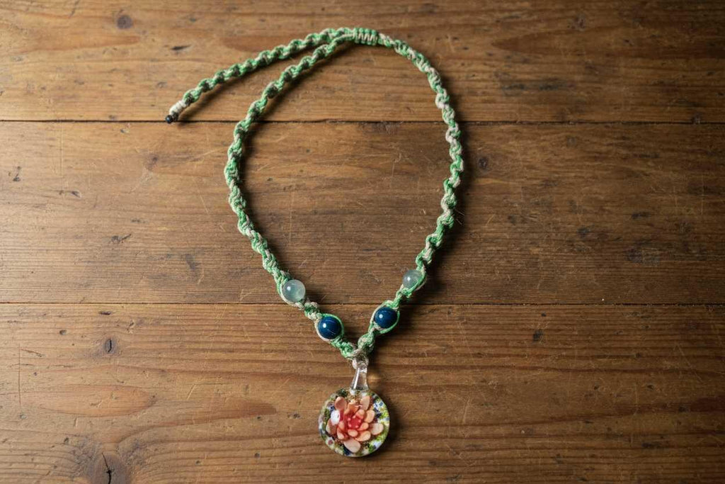 Necklace with a floral pendant on a wooden surface