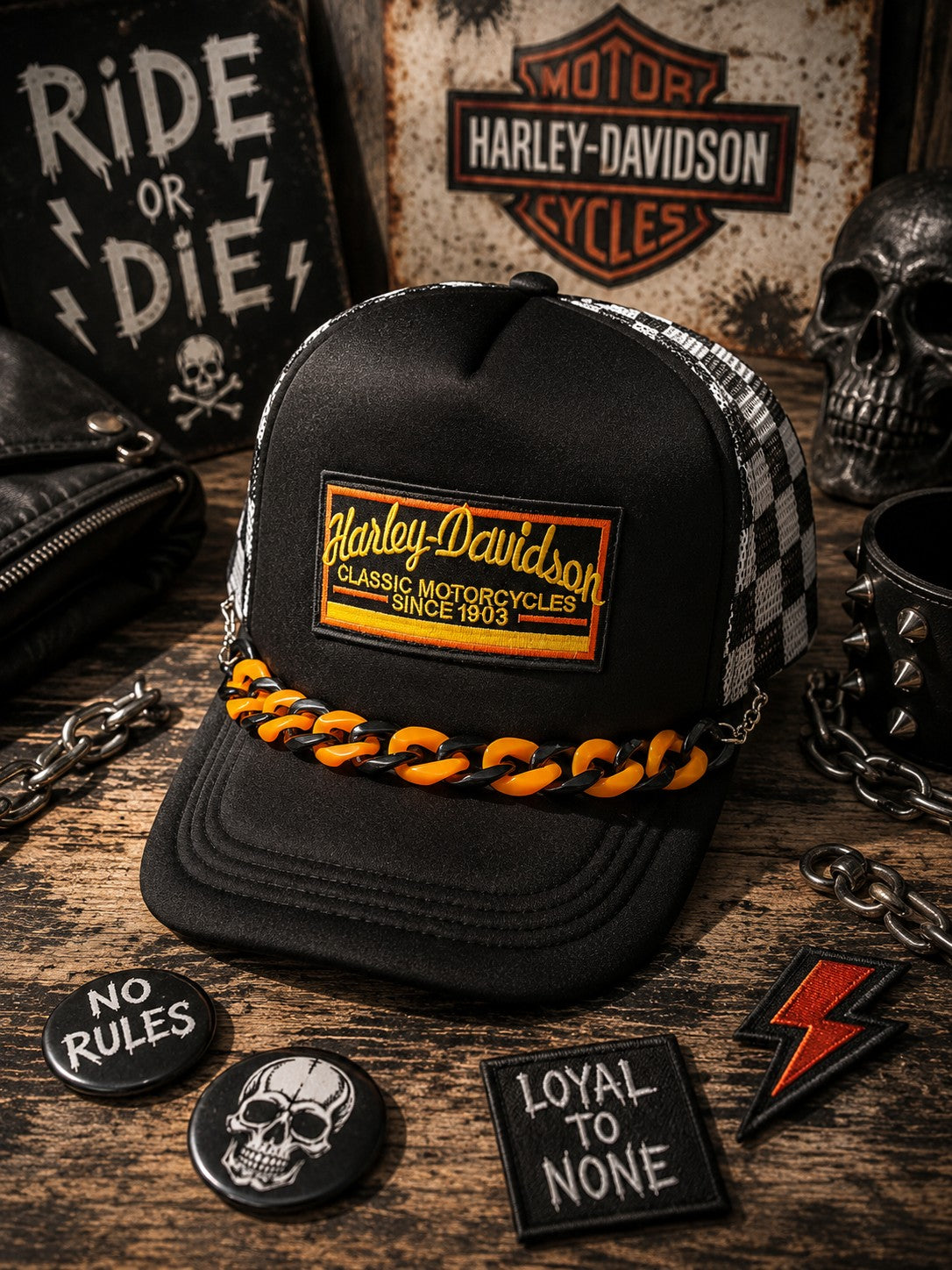 Hempin Mayhem black trucker hat with Harley-Davidson patch, checkered mesh back, and orange and black chain detail.